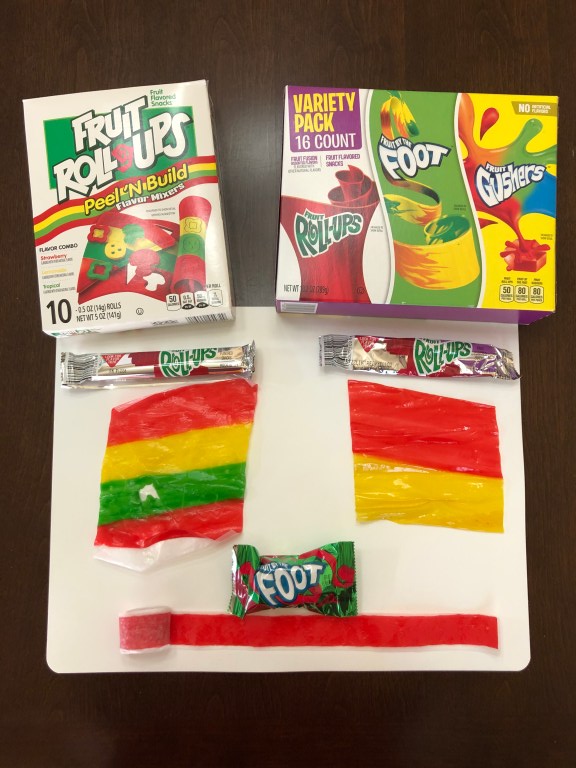 Roll out your Fruit Roll-Ups. This is one of the candies you'll use to create your Wonder Woman candy topper.