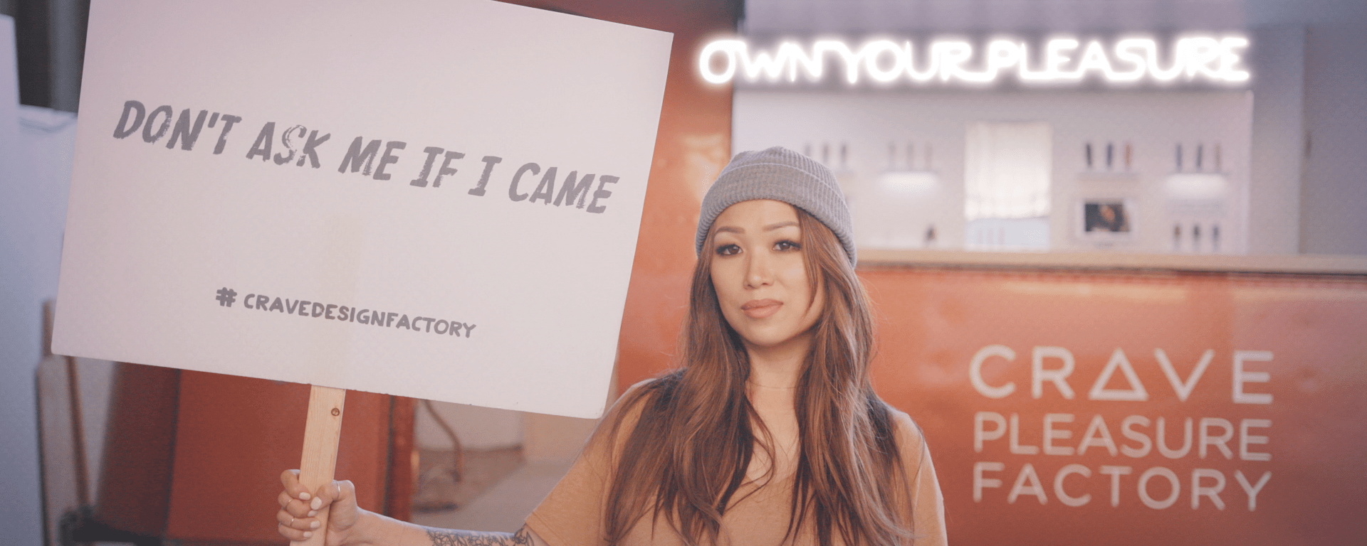 Woman holds up "Don't Ask Me If I Came" sign in documentary film, "The Dilemma of Desire"