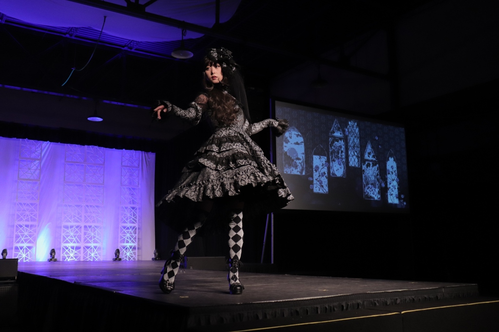 A model struts the runway donning lolita-inspired clothing from Alice and the Pirates at A-Kon 30.