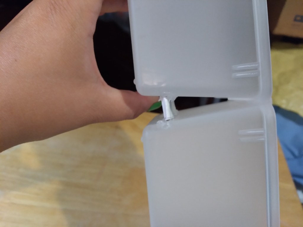 Since my bins are slightly angled, I used cardboard to make small wedges and glued them in the back between the bins to make sure they were flat.