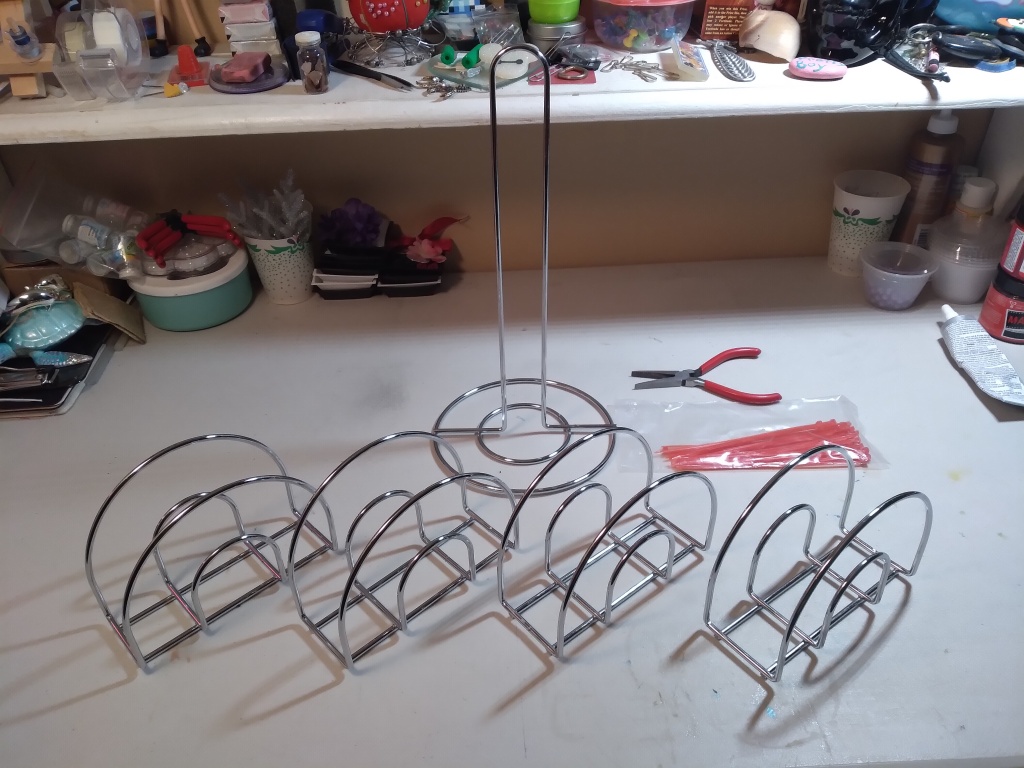 Items you need to create a paint rack: 4 napkin holders, 1 paper towel holder, and zip-ties