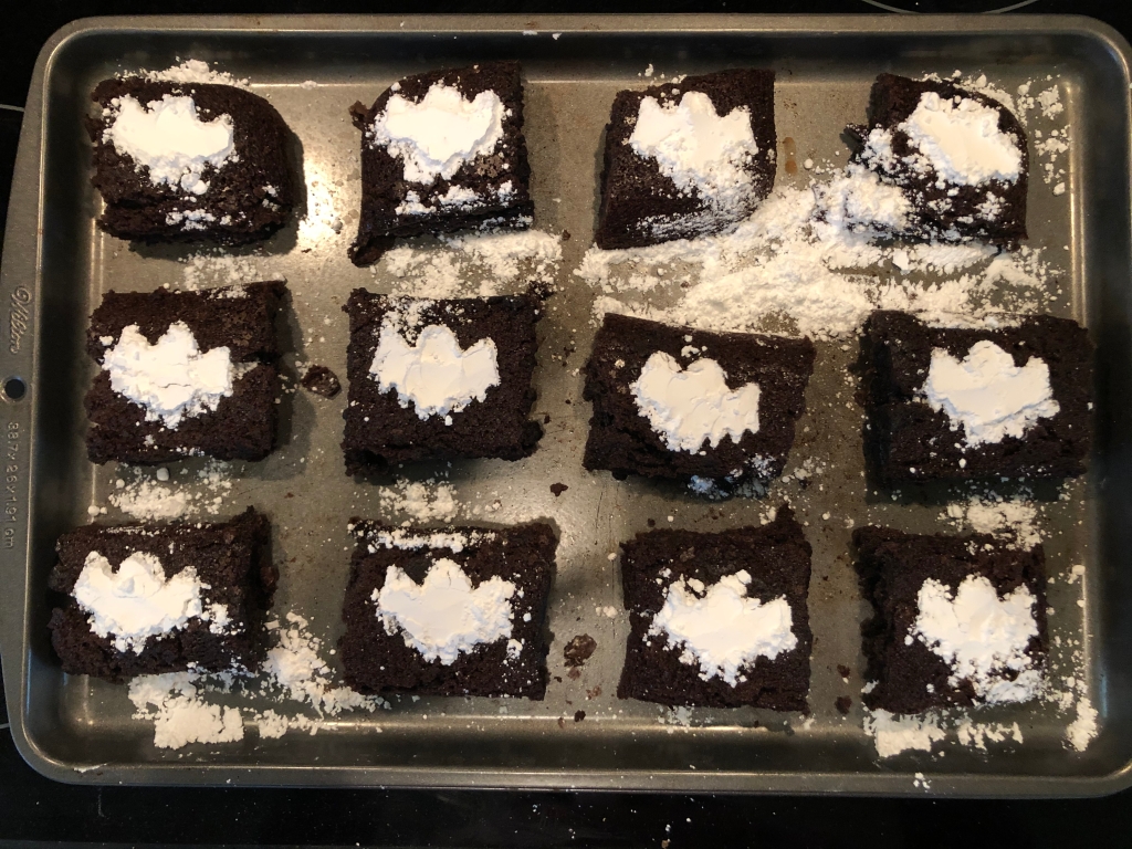 Ghost-shaped powdered sugar on brownies 