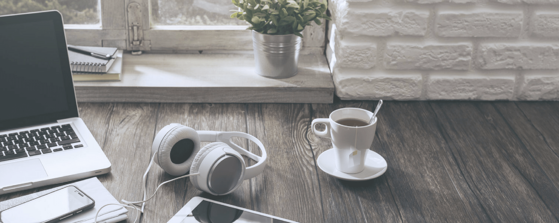 laptop with headphones and tea