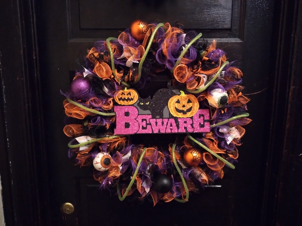Learn how to make a Halloween wreath! Our writer Melissa Joy made one and hung it on her black door.