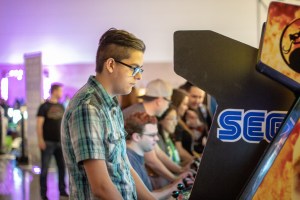 guy plays arcade game