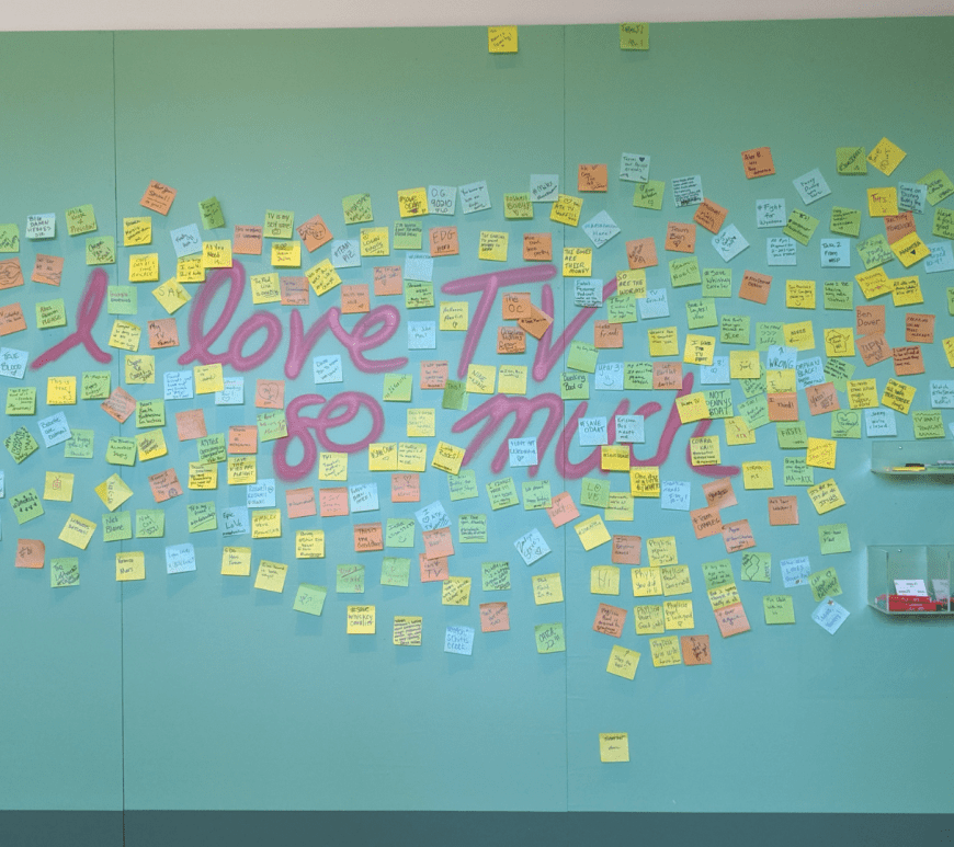 On the wall where it says "I love TV so much," visitors left Post-Its stating why they love TV so much.