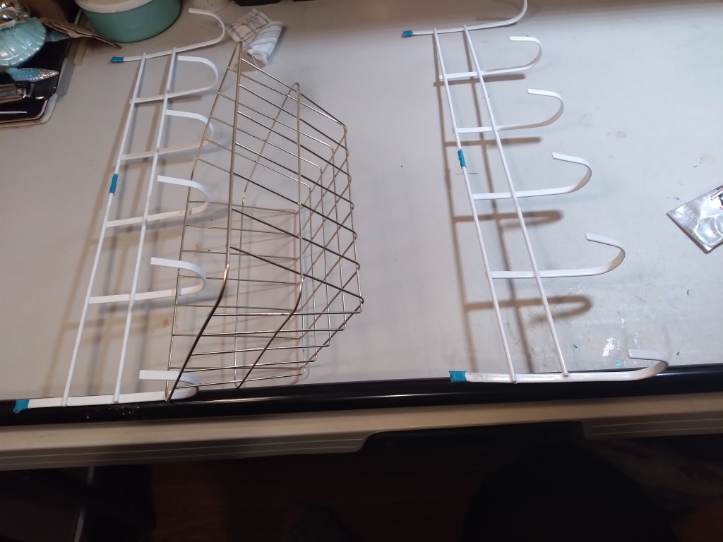 Lay one of the broom poles and line up one end of the door hanger against the pole